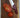 Cardinal Red Chef Knife with Tomatoes and Wood Cutting Board on Marble Counter