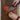 A Cardinal Red Chef Knife Cutting an Heirloom Tomato on Rustic Wood Board on Marble Countertops