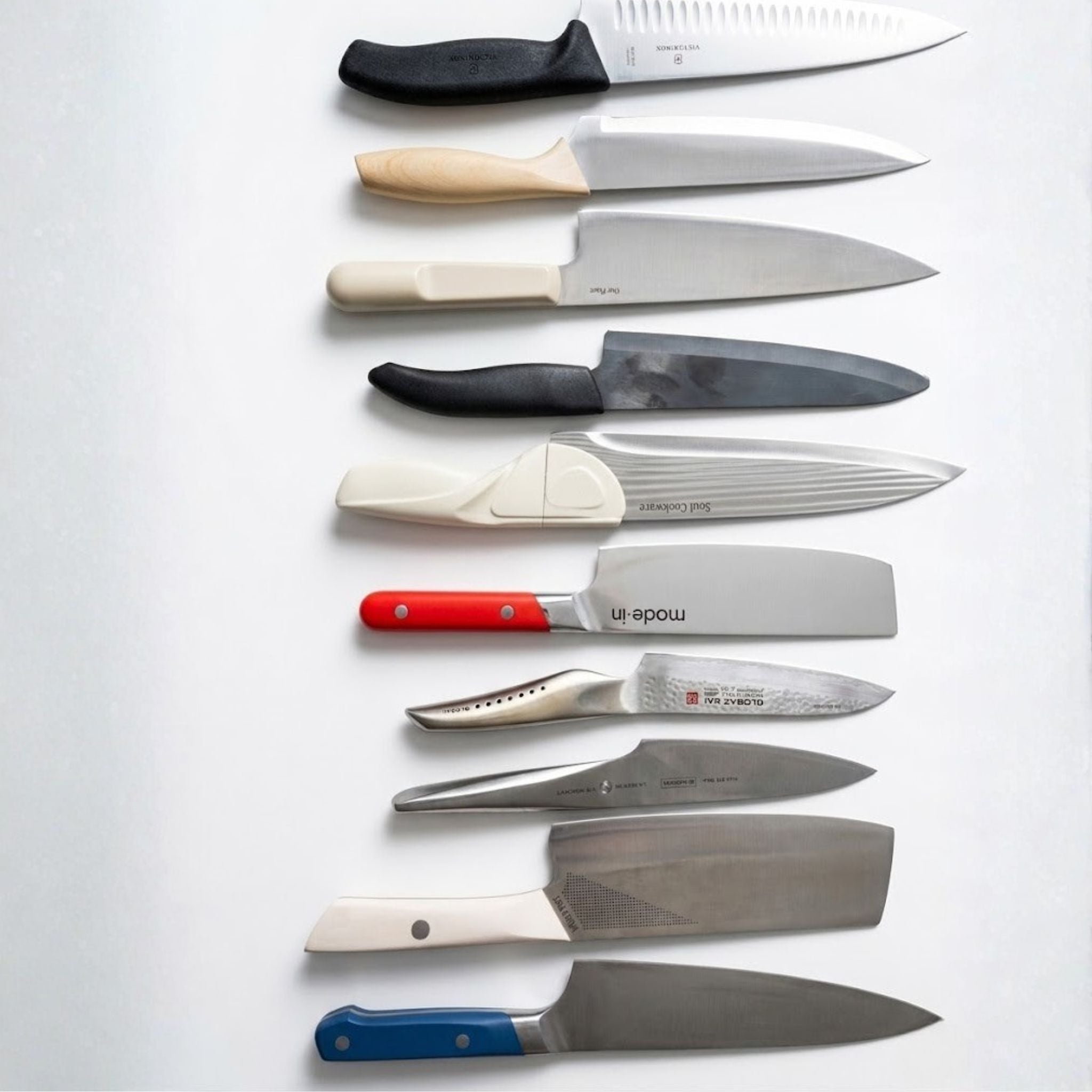 Set of knives with various handles on a white background