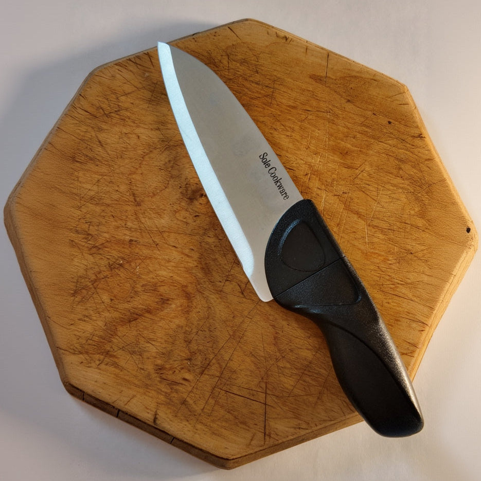 Knife with a Brown Grey handle on a wooden cutting board