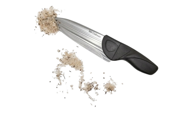 Metallic fish scaler with Salt on a white background