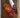 Cardinal Red Chef Knife with Tomatoes and Wood Cutting Board on Marble Counter
