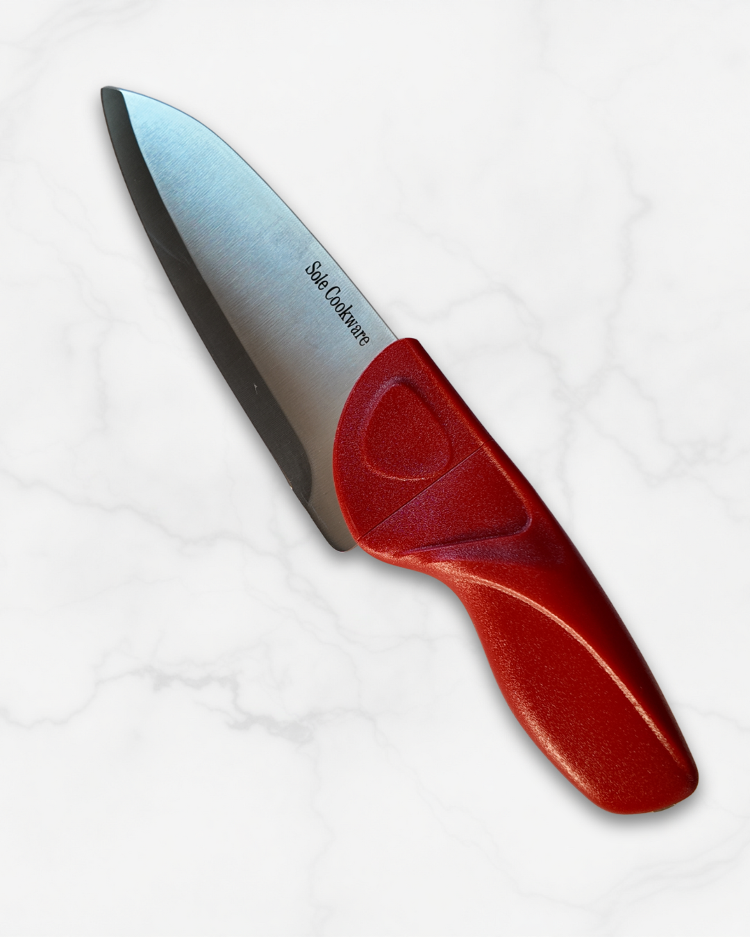 Chef knife with a red handle on a white background