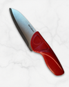 Chef knife with a red handle on a white background